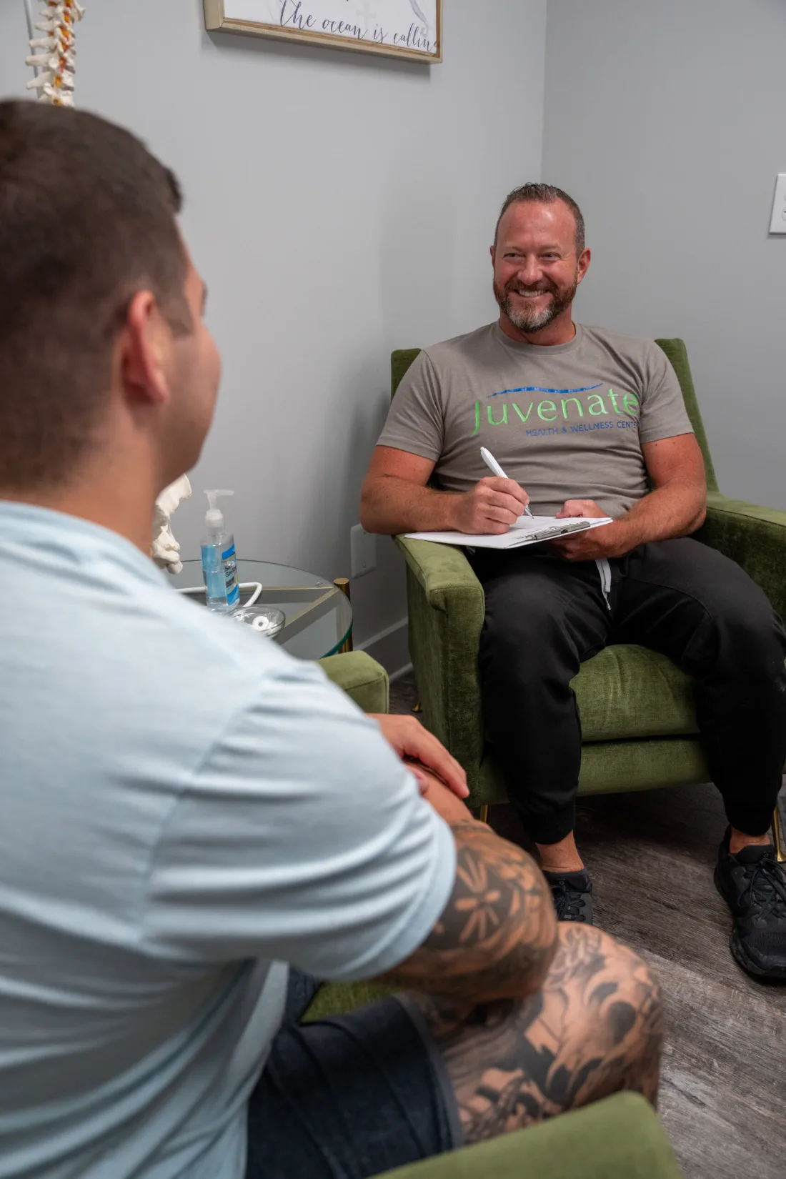 Brad Whitfield, APRN, smiling during a hormone therapy consultation at Juvenate