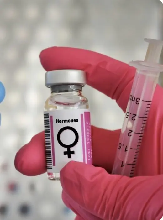 Provider holding a women’s hormone vial